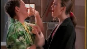 Two people animatedly talking; one wearing a Hawaiian shirt, the other in a dark jacket.