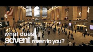 A bustling train station with an American flag and large windows, overlaid text: "what does advent mean to you?.