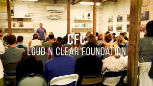 Room of people seated, facing a speaker in front of a whiteboard. Text overlay: "CFC Loud N Clear Foundation.